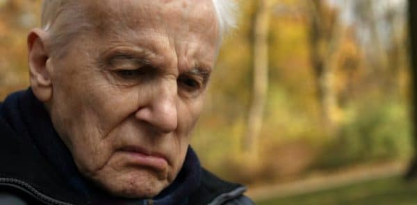 Distressed Elderly Gentleman Walking Outdoors Stock Photo
