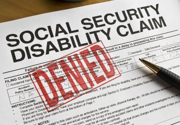 A disability claim form with the word “DENIED” stamped in large, red letters.